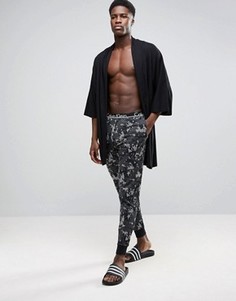 Джоггеры классического кроя с манжетами и камуфляжным принтом Calvin Klein - Зеленый