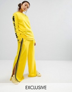Широкие брюки с контрастной атласной полосой сбоку Ellesse - Желтый