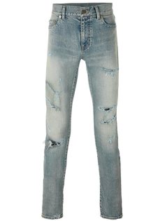 джинсы скинни с рваными деталями Saint Laurent