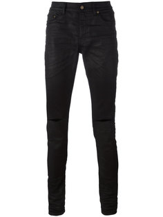 джинсы с рваными деталями Saint Laurent