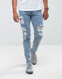 Светлые эластичные узкие джинсы с рваной отделкой ASOS - Синий