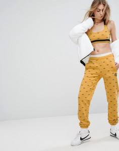 Спортивные брюки со сплошным принтом логотипов Umbro - Желтый