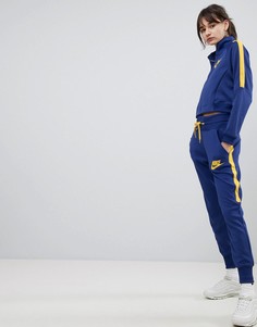 Желто-синие спортивные брюки с завышенной талией Nike - Синий