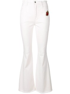 Dolce & Gabbana расклешенные джинсы с заплаткой Sacred Heart