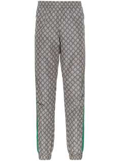 Gucci спортивные брюки с узором GG Supreme и отделкой Web