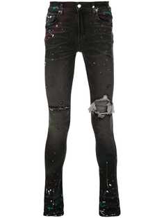 Amiri джинсы с эффектом разбрызганной краски и прорезями