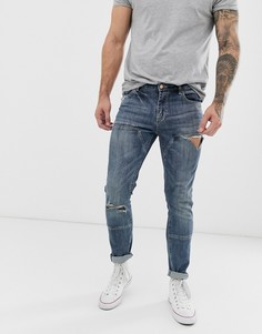 Темно-синие зауженные джинсы со вставками и рваной отделкой ASOS DESIGN - Синий