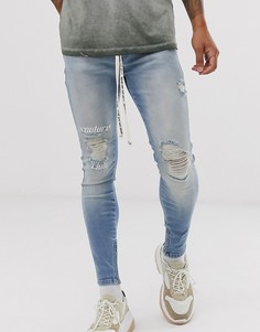 Синие выбеленные джинсы скинни с логотипом на колене и рваной отделкой The Couture Club - Синий