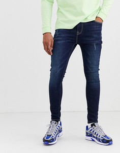 Темно-синие эластичные джинсы с напылением и потертостями ASOS DESIGN - Синий