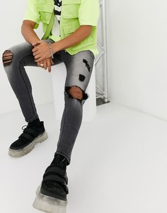 Черные рваные эластичные джинсы с напылением ASOS DESIGN
