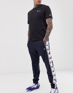 Темно-синие брюки с кантом на манжетах Champion