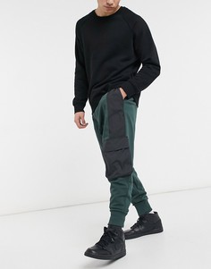 Темно-зеленые джоггеры в стиле oversized с нейлоновыми вставками черного цвета и широкой отделкой в рубчик ASOS DESIGN-Зеленый цвет
