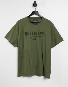 Меланжевая однотонная футболка оливкового цвета из технологичного материала с логотипом Hollister-Зеленый цвет