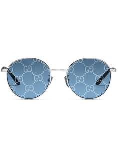 Gucci Eyewear солнцезащитные очки с узором GG в круглой оправе