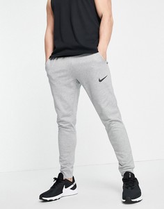 Суженные книзу джоггеры светло-серого цвета из ткани Dri-FIT Nike Training-Серый