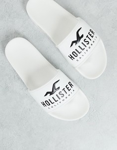 Белые шлепанцы с фирменным логотипом Hollister – эксклюзивно для ASOS-Белый