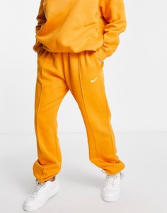 Оранжевые джоггеры в стиле oversized с маленьким логотипом-галочкой Nike-Желтый