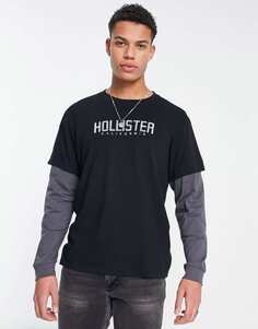 Черная футболка с длинными рукавами Hollister, серой нижней частью рукава и логотипом на груди