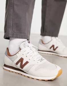 Кроссовки New Balance 373 кремово-белого и коричневого цветов.